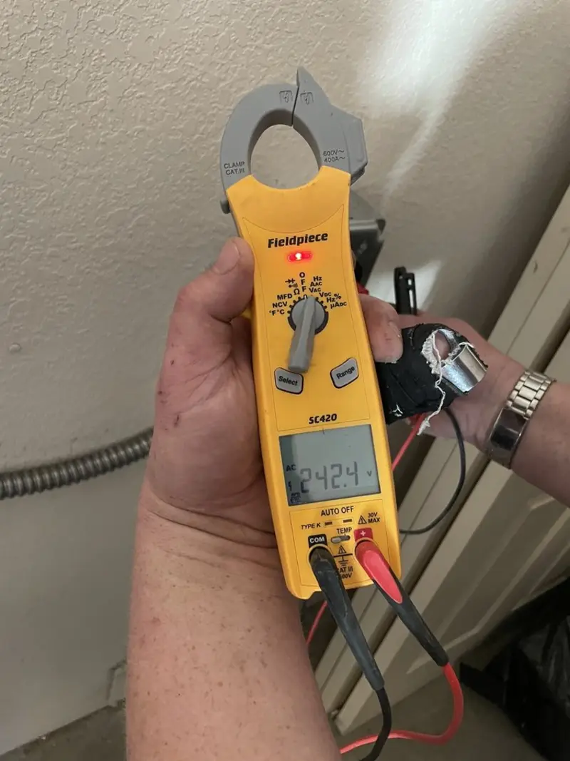 Voltage testing with clamp meter during Generator Installation in Roeland Park